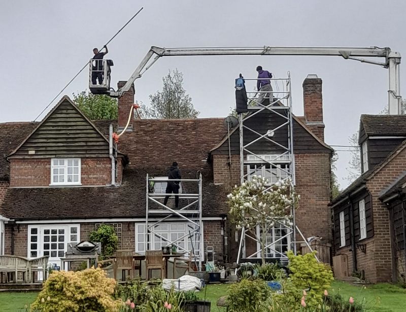 The Roof Moss Cleaners using cherry picker and scaffolding to clean roof safely and professionally in Gerrards Cross, Buckinghamshire