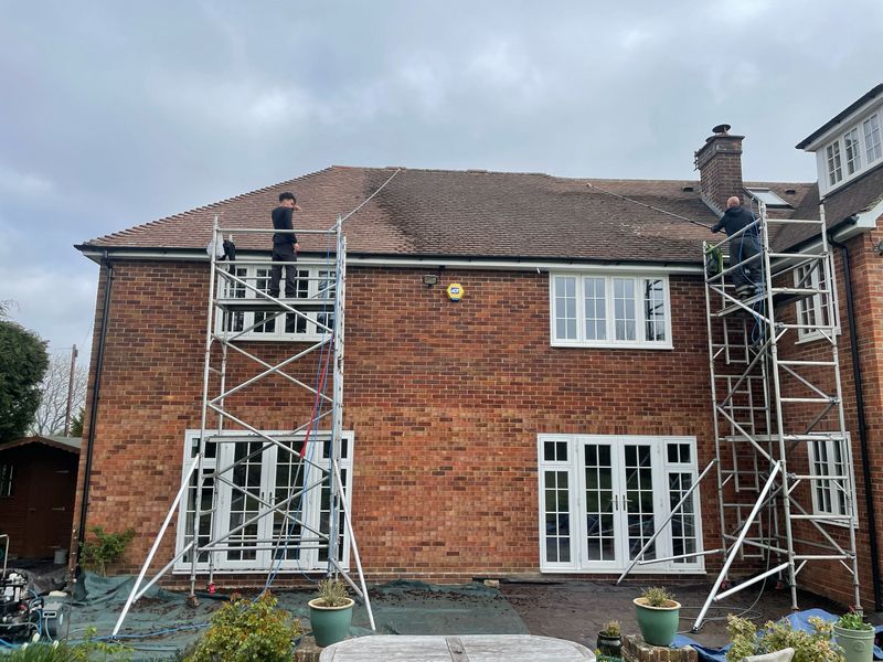 Roof cleaning carried out safely from scaffold towers by The Roof Moss Cleaners in Gerrards Cross